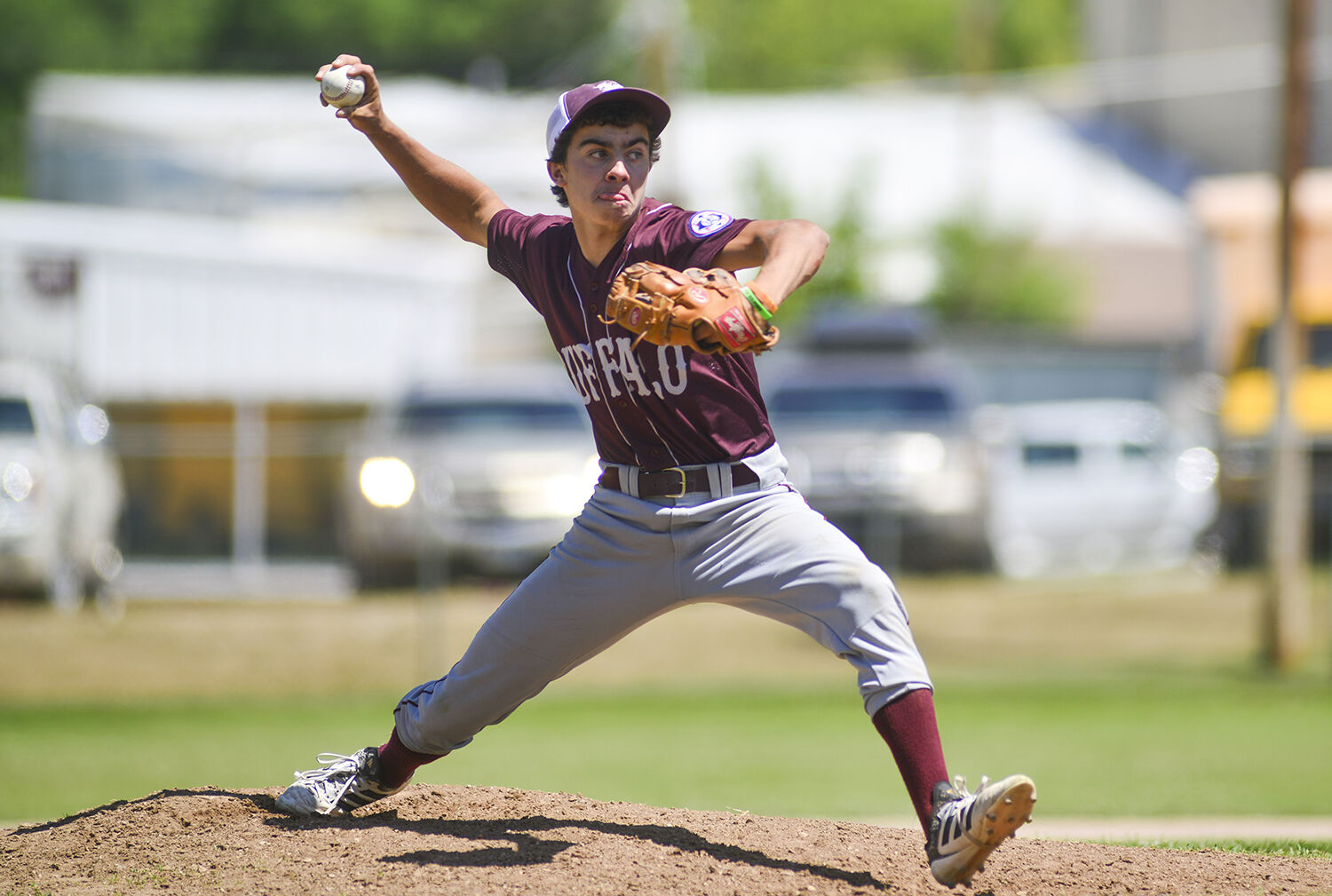 Joe Musselman sticks out his tongue as he stretches for his pitch against the first batter